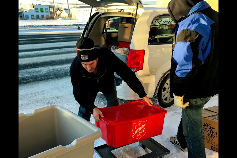 Salvation Army volunteer Conrad Zunti unloads a delivery of fresh, leftover grocery story food for the food bank, Nov. 16, 2018. Zunti volunteers as a driver Monday, Wednesday, and Friday.