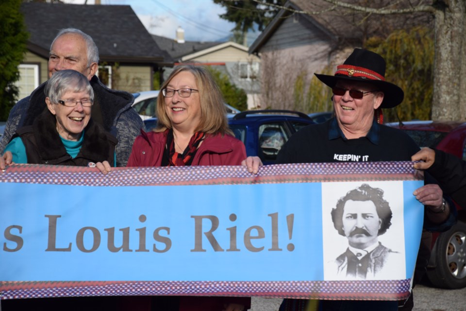 Historian Terry Goulet, Sechelt Mayor Darnelda Siegers and Ron Paradis, president of the United Canadian Métis Nation take part in the flag raising ceremony in Sechelt.