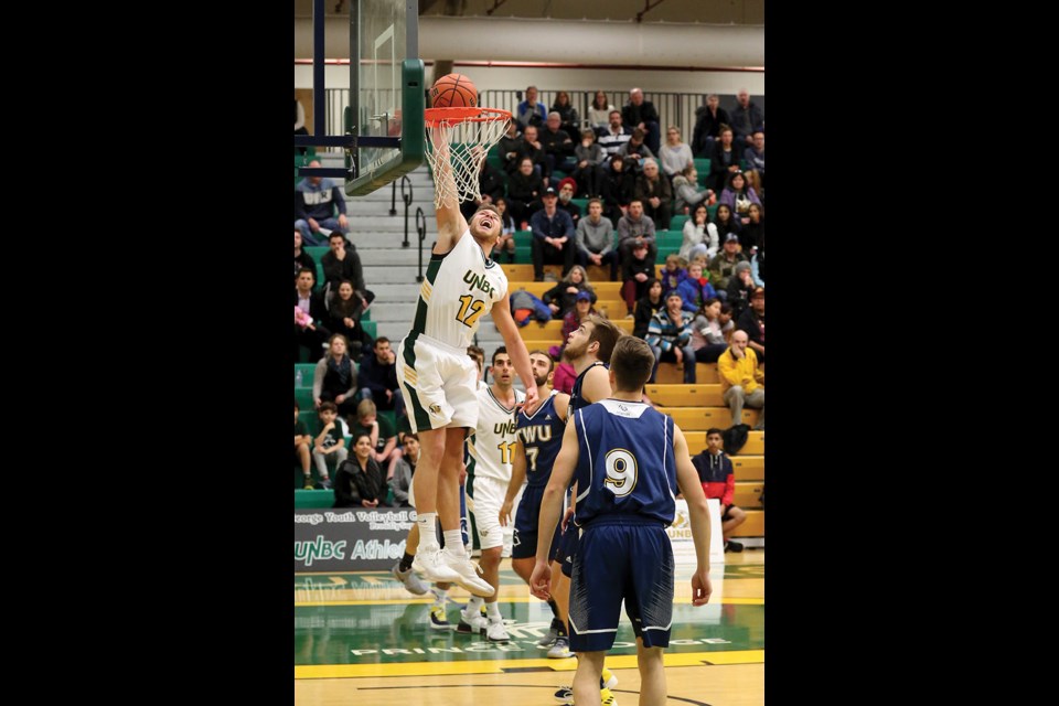 T-wolves forward Austin Chandler goes in for a dunk against the Trinity Western University Spartans during Friday's agame at the NSC. UNBC swept the weekend series to improve to 5-1.