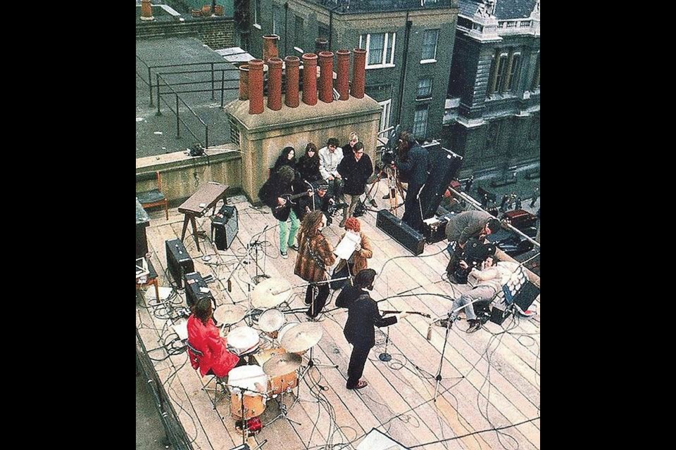Yoko Ono, Maureen Starkey, U.S. Apple representative Ken Mansfield and Chris O’Dell sit on a bench listening to The Beatles perform live up on the roof at Apple Studios, 3 Savile Row, London, U.K., Jan. 29, 1969.