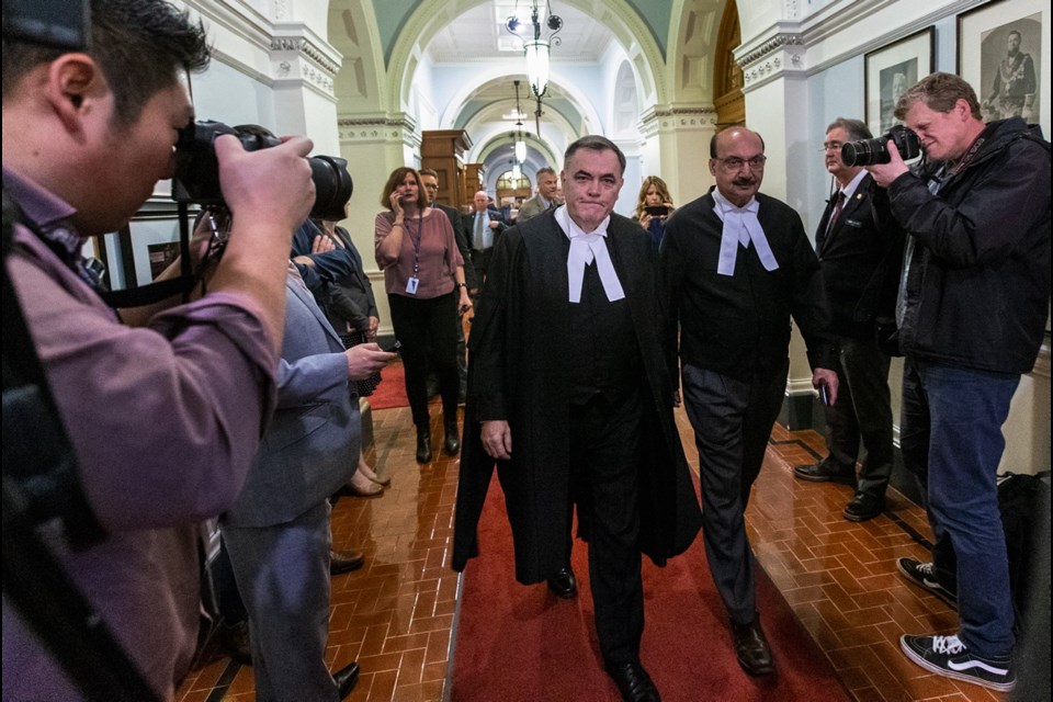 Speaker Darryl Plecas, centre, walks to his office with Deputy Speaker Raj Chouhan along the Speaker's Corridor at the legislature Thursday. Nov. 22, 2018