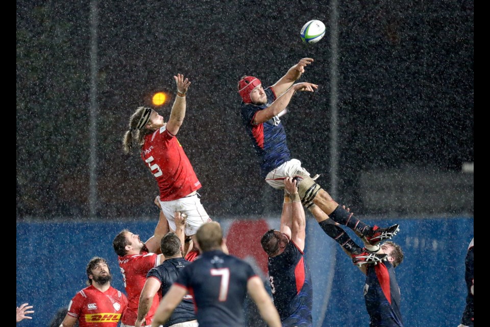 Canada's Evan Olmstead, left, and Hong Kong's Fin Field, challenge for the ball, during the 2019 Japan Rugby Union World Cup qualifying match between Canada and Hong Kong, in Marseille, France, Friday, Nov. 23, 2018. (AP Photo/Claude Paris)