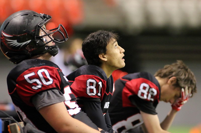 MARIO BARTEL/THE TRI-CITY NEWS
The reaility of their 33-0 loss to the New Westminster Hyacks in Saturday's Subway Bowl AAA semi-final sinks in for Liam Stewart, Joshua Morris and Jake McEwan of the Terry Fox Ravens.