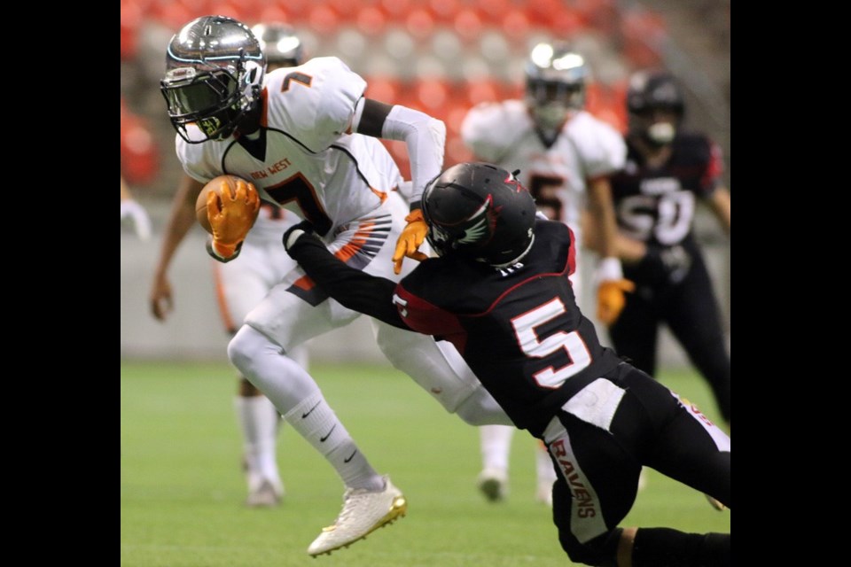 MARIO BARTEL/THE TRI-CITY NEWS New Westminster Hyacks wide receiver Ajay Choi tries to break the tackler of Terry Fox Ravens safety Kyle Huish in their BC Secondary Schools Football Association AAA Subway Bowl semi-final, Saturday at BC Place Stadium. New Westminster won the game, 33-0.