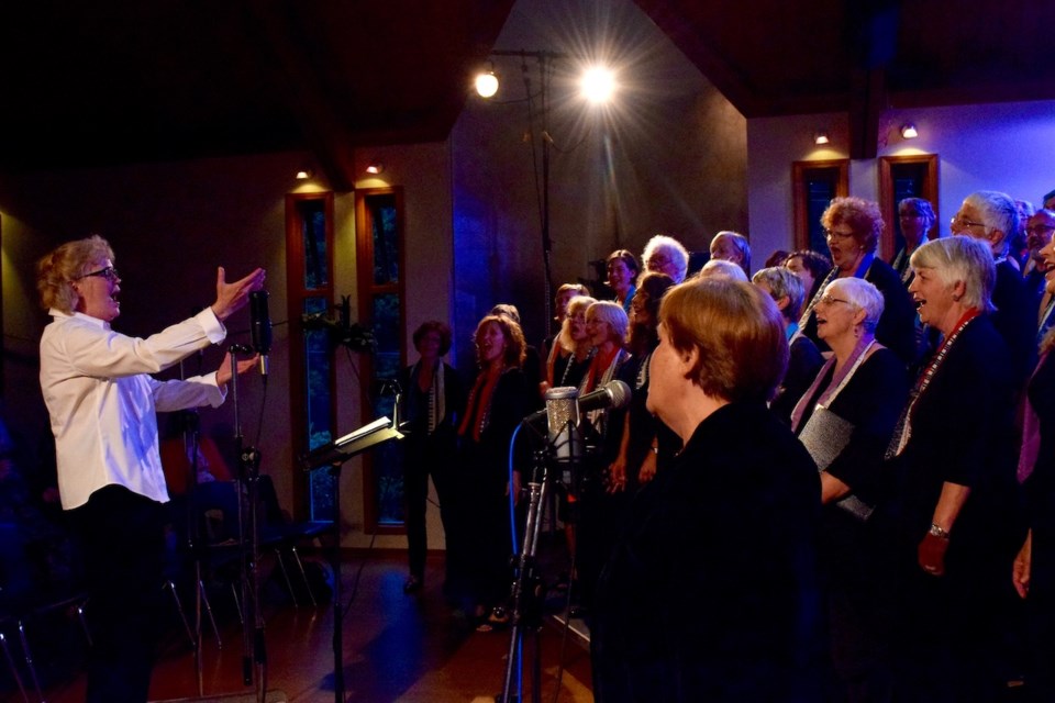 Ellen MacIntosh leads the Bowen Island Community Choir in song.