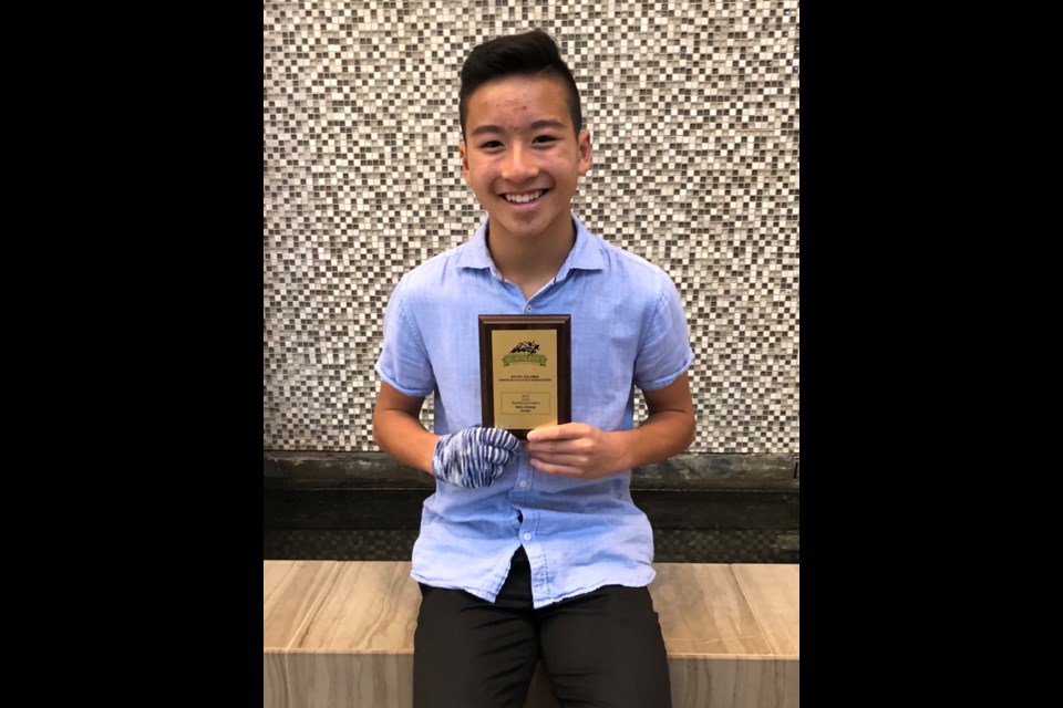 New Westminster's Kairo Chiang receive an award from B.C. Athletics last month in honour of his performance in both the pole vault and triple jump.