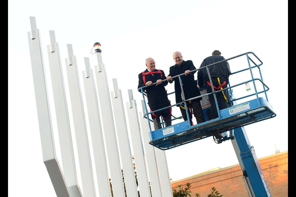 Mayor Malcolm Brodie was joined on the hoist by former Premier Bill Vander Zalm for the lighting of a giant 30-foot menorah to mark the start of Hanukkah outside Richmond Cultural Centre. Boaz Joseph photos