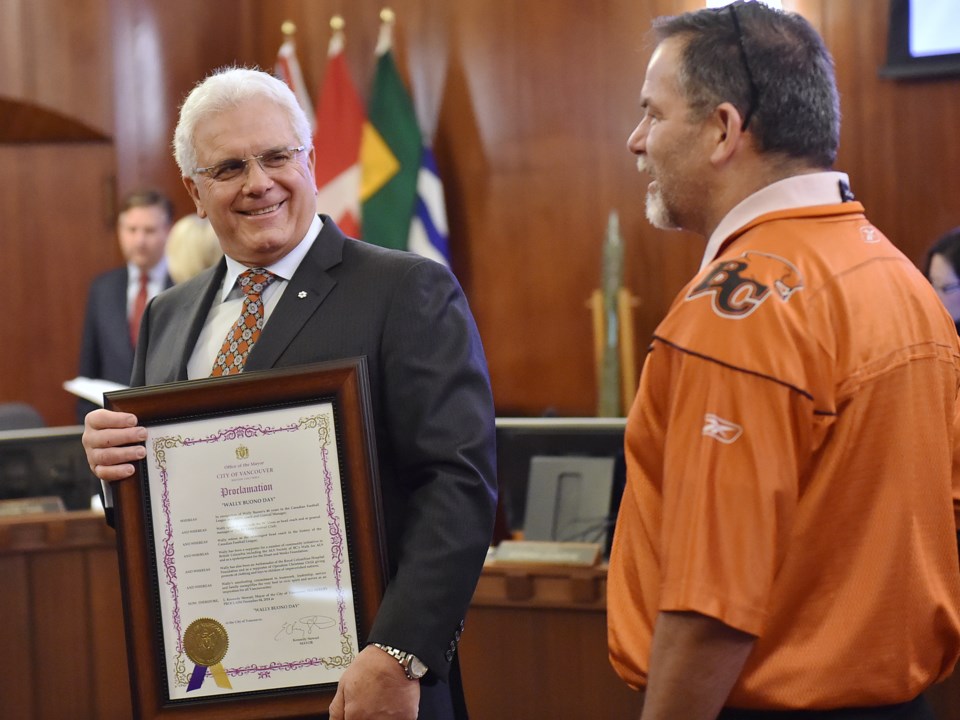 Longtime fan Gordon McDonald chats with Wally Buono after the ceremony at city hall. Photo Dan Toulg