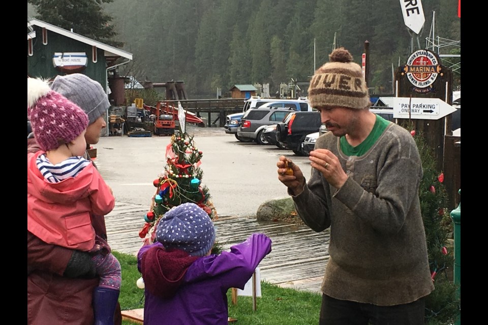 Jen Lafferty and her children with star volunteer Noah Pryce-Jones decorating some firs for the Festival of Trees Friday.