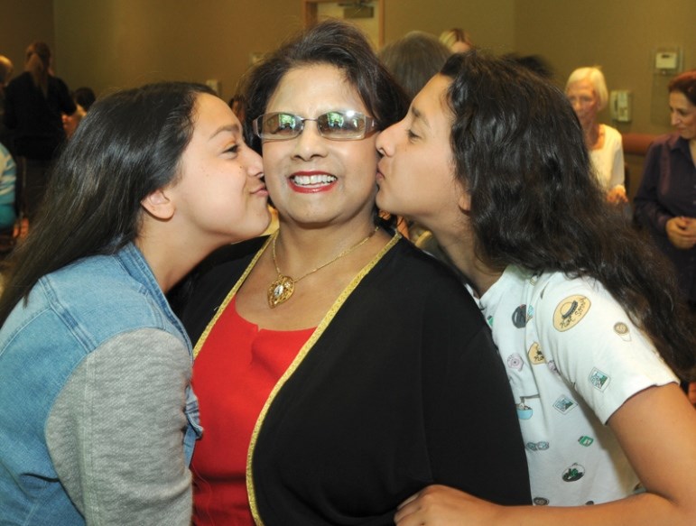 Sylvie Pather gets some love from her granddaughters Maya and Sophie Pather at the United Way Community Spirit Awards at North Shore Neighbourhood House in May 2017. photo Mike Wakefield, North Shore News
