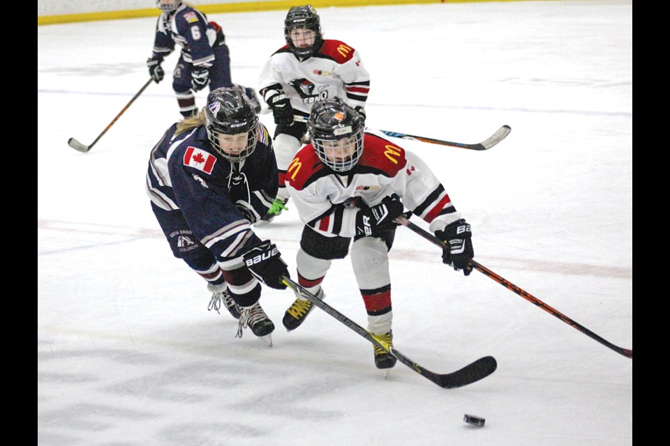 Castilla Rubin (left) of the North Shore Avalanche sweeps for the puck during the WickFest tournament held recently in Calgary. photo supplied