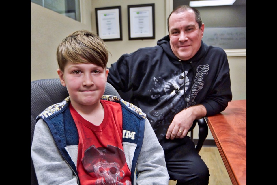 Denver McKinlay, pictured here with dad, Matt, pounded a lot of pavement as he secured donations for the KTW Christmas Cheer Fund on behalf of the Western Karate Academy.