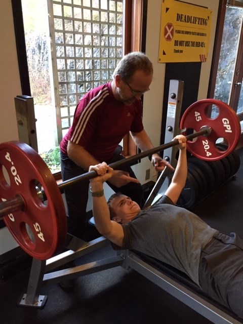 Rob Wynen spots his son during a workout.