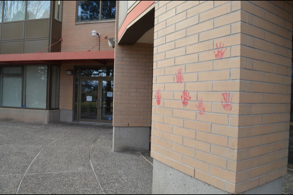 Handprints dipped in red ink were plastered on the outside wall of the Campus Activity Centre at TRU on Dec. 10, 2018.