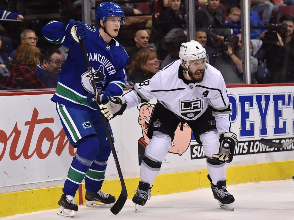 Elias Pettersson battles an incredulous Drew Doughty.