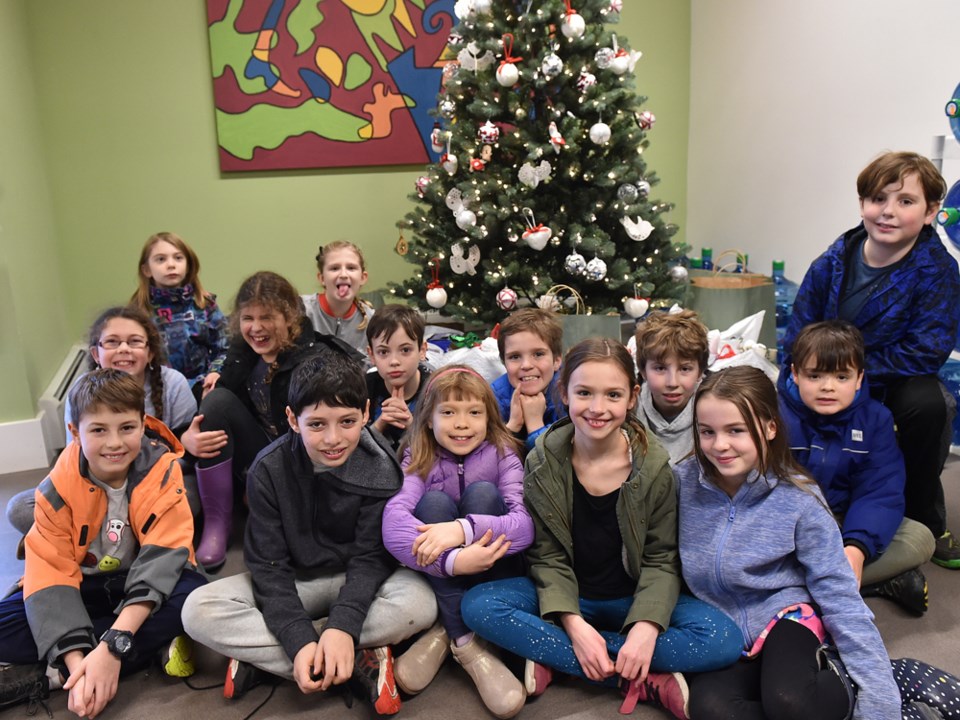 Lord Tennyson after-school program brings donations to the Courier for Directions Youth Services. Ph