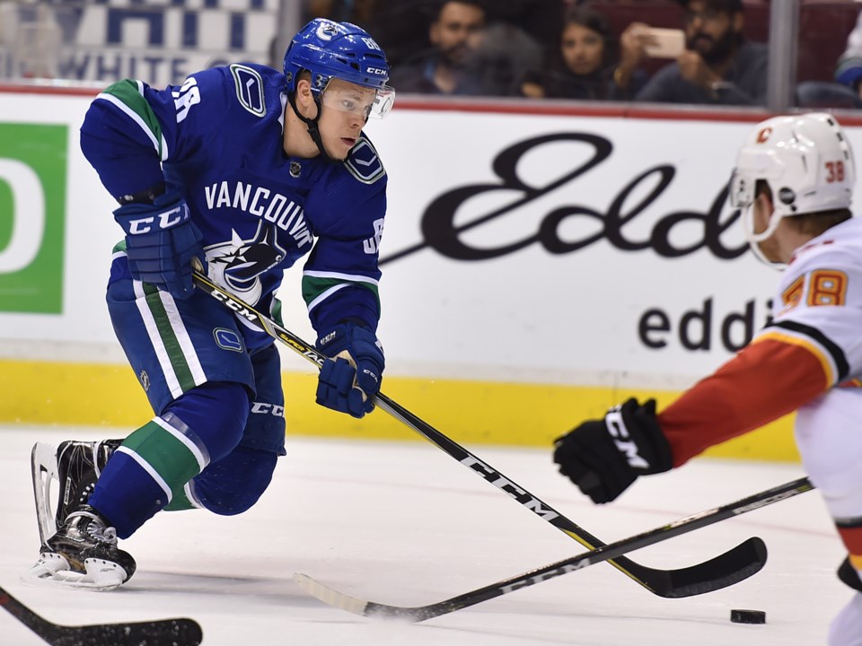 Petrus Palmu carries the puck in the 2018 pre-season for the Vancouver Canucks.