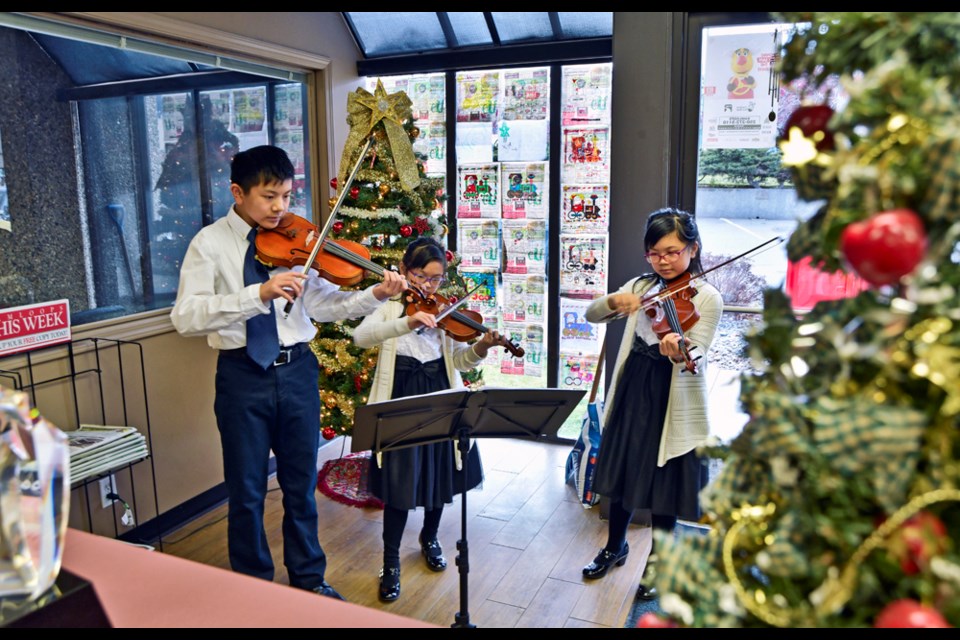 Thirteen-year-old Wesley Mah (left), sisters Christina, 9, and Vanessa, 11, dropped by the Dalhousie Drive office of Kamloops This Week to play Christmas music and donate to the KTW Christmas Cheer Fund. The Mah family has used its musical talents to help the city’s less fortunate. The three children have been playing together for more than five years and their appearance at KTW is an annual Cheer tradition.