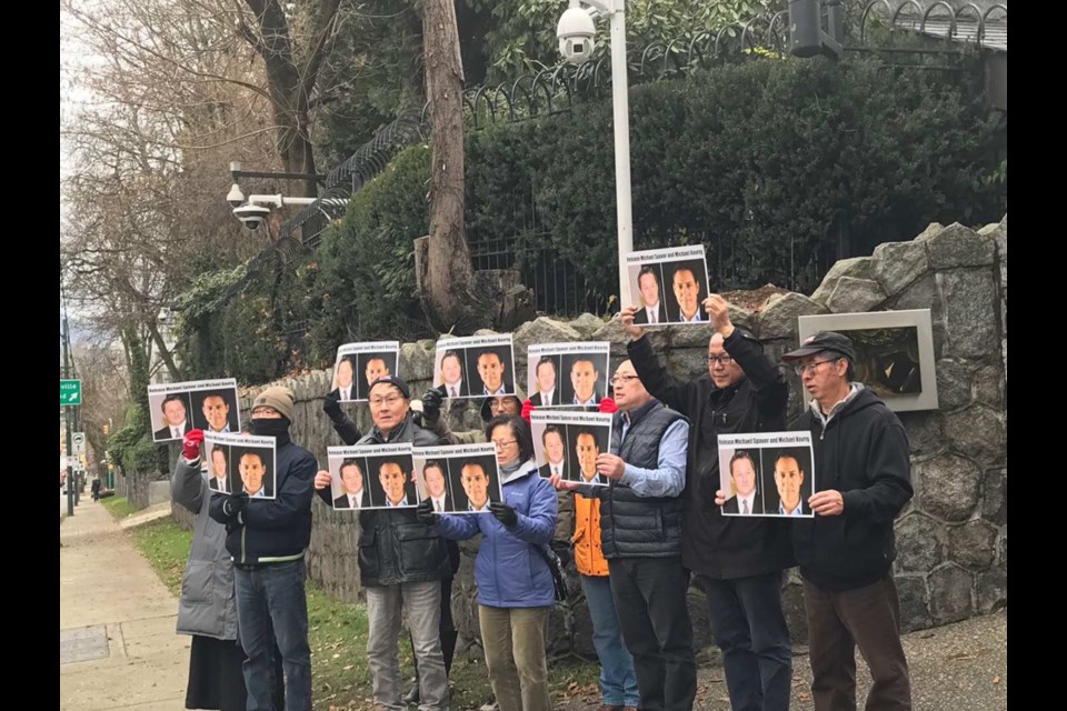 Around 10 residents held pictures of the two Canadians and shouted “Respect the Canadian legal system. Release Michael Kovrig. Release Michael Spavor” in front of the Chinese consulate in Vancouver last Saturday. Photo submitted