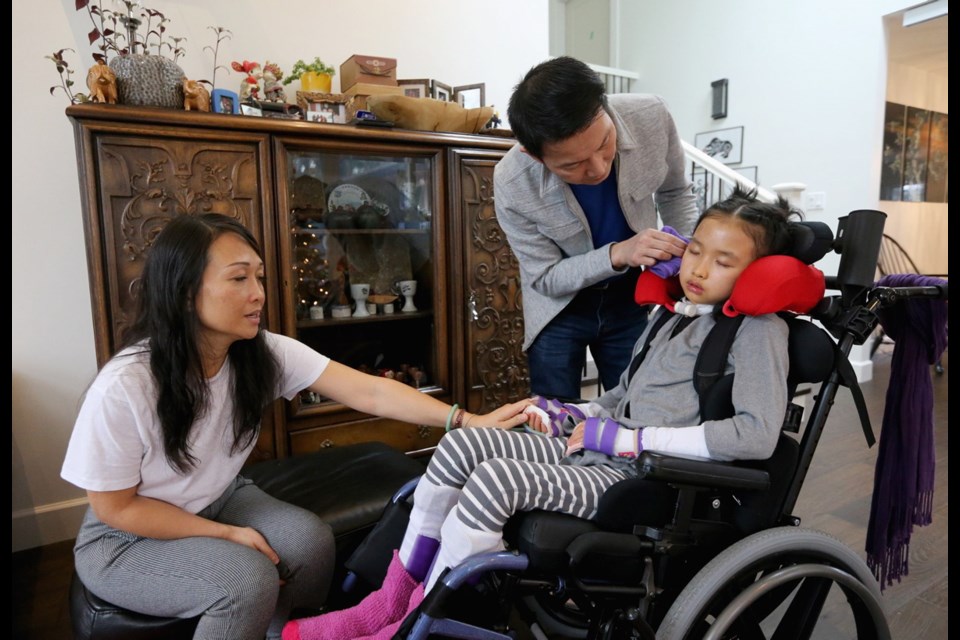 Kairry and Tuan Bui with their daughter Leila at their Saanich home. "My husband and I have hope that she's young, she could recover," says her mother. "I know it's not going to happen instantly."