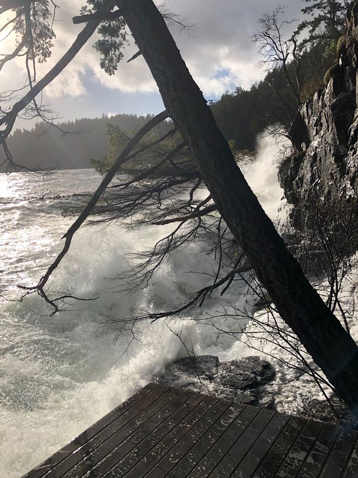 Waves crash against a rock face during today's windstorm.