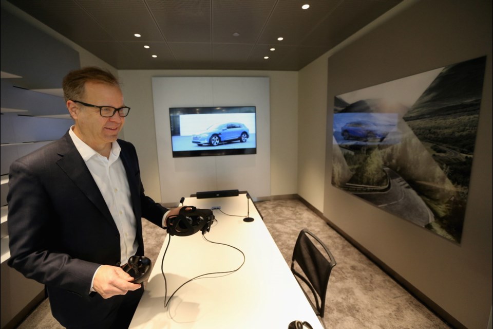 Audi Victoria general manager Carl Munro shows off the high-tech room at the dealership at 2929 Douglas St.