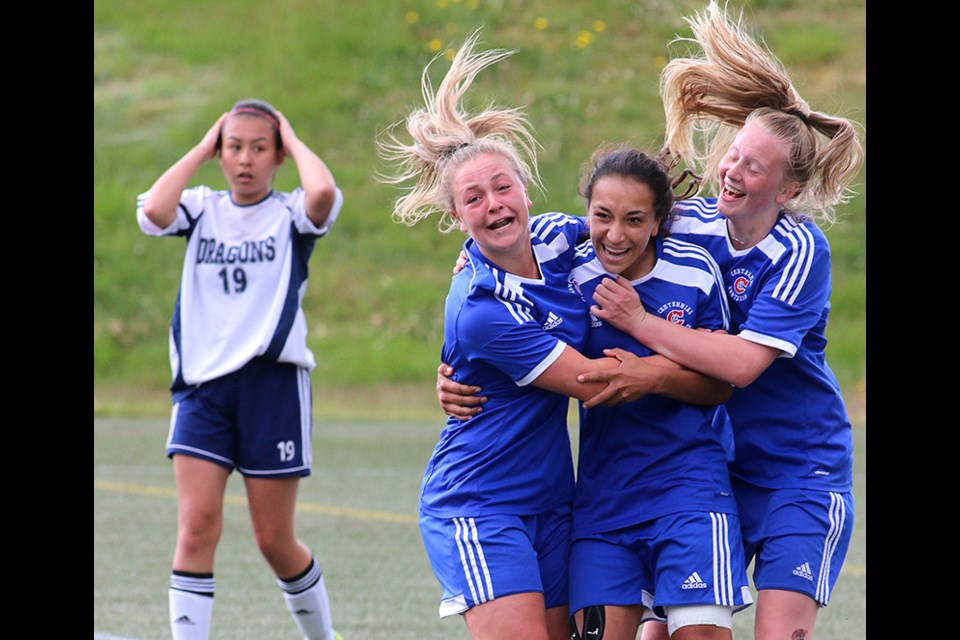 MARIO BARTEL/THE TRI-CITY NEWS
Centennial Centaurs forward Sophia Ferreira, centre, is hugged by teammates Meghan Harder and Raegan Mackenzie, after she scored the winning goal in their 1-0 win over the Fleetwood Park Dragons in Friday's BC High School AAA senior girls soccer championship at the University of British Columbia's Thunderbird Stadium. Shooting sports is part luck, part intuition and part absorbed knowledge. Time was running out in the senior girls high school soccer championship that was scoreless late in the match so I moved from my usual shooting position along the end touch line to a spot on the sideline between the benches to better my chances of capturing any sort of reaction should a goal be scored. Then, it was.