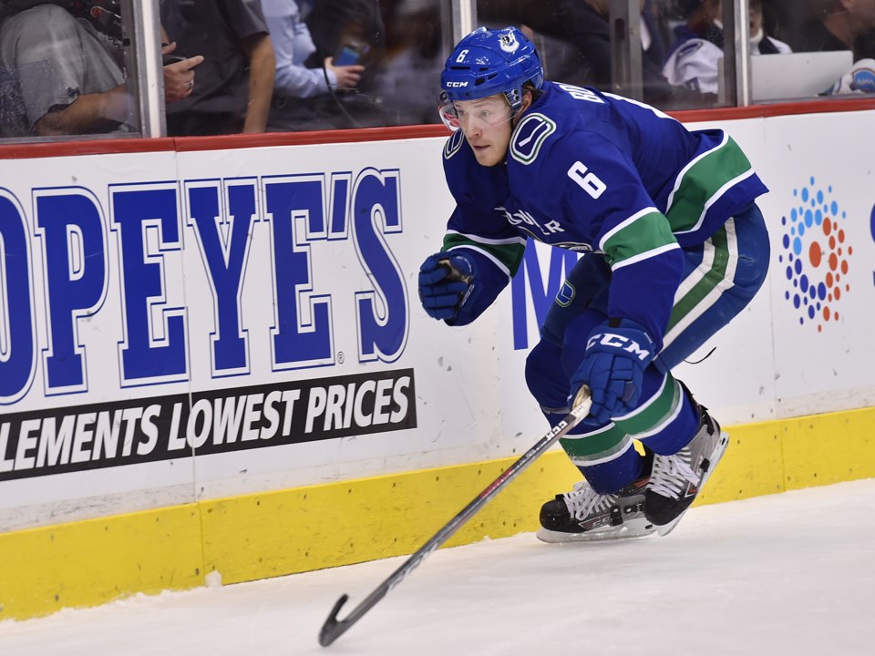 Brock Boeser chases the puck up the boards for the Vancouver Canucks