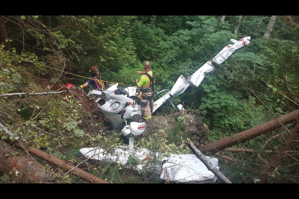 Crews work to stabilize the wreckage of a small plane that crashed near the Sechelt Airport July 5, killing the pilot.