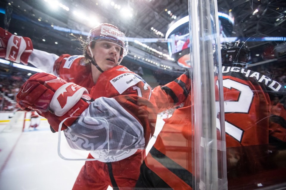 Denmark's Lucas Andersen, left, and Canada's Evan Bouchard collide during second period IIHF world junior hockey championship action in Vancouver, on Wednesday December 26, 2018.