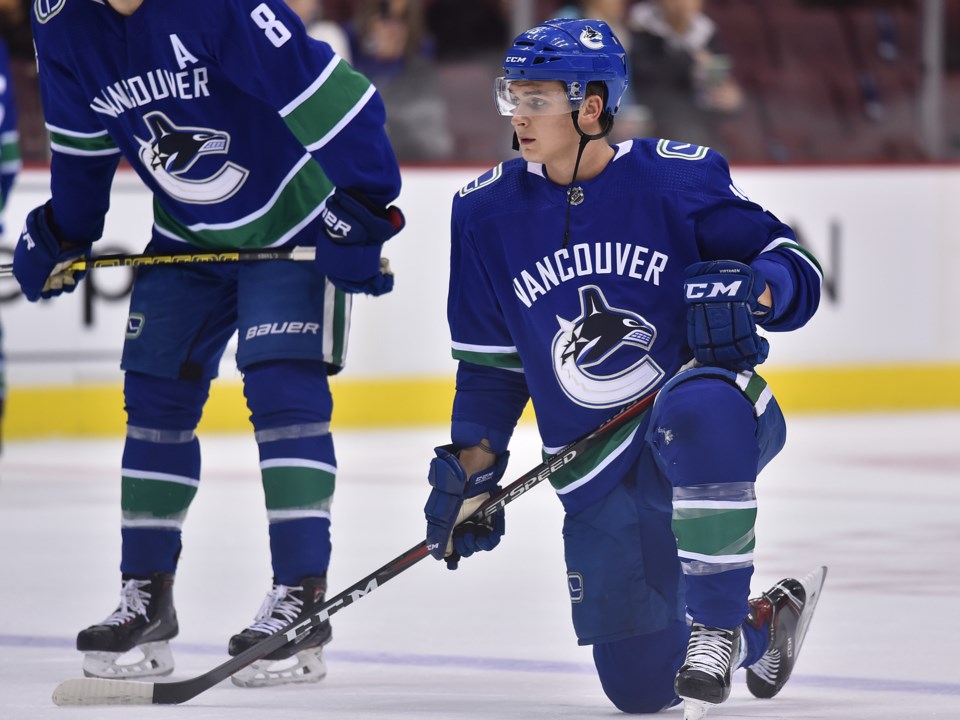 Jake Virtanen takes a knee during warm up with the Vancouver Canucks