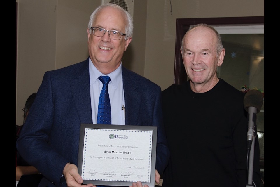 Mayor and one-time member Malcolm Brodie was honoured for his longtime support of the Richmond Tennis Club during its annual Christmas party. Presenting him with a certificate of appreciation is club president Kim Jensen.