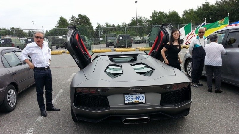 Richmond fraudster Paul Oei gets out of a Lamborghini with his wife, left, Loretta Lai, at the Sherm