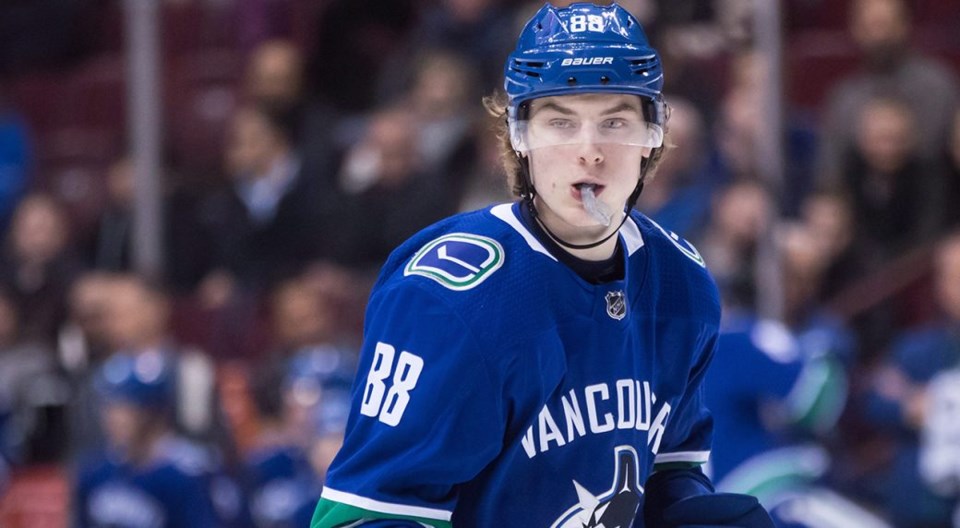 Adam Gaudette with mouth guard hanging out for the Vancouver Canucks.