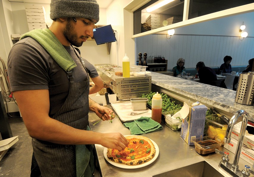 Joe Lauriente stretches the dough on a pizza before it goes into the woodburning oven at the new Nicli Antica Pizzeria in Edgemont Village.