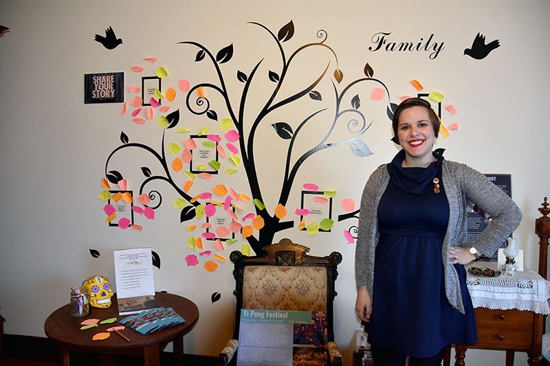 Abby Brown-John with the interactive family tree in Grandma's Room, at Mackin House.