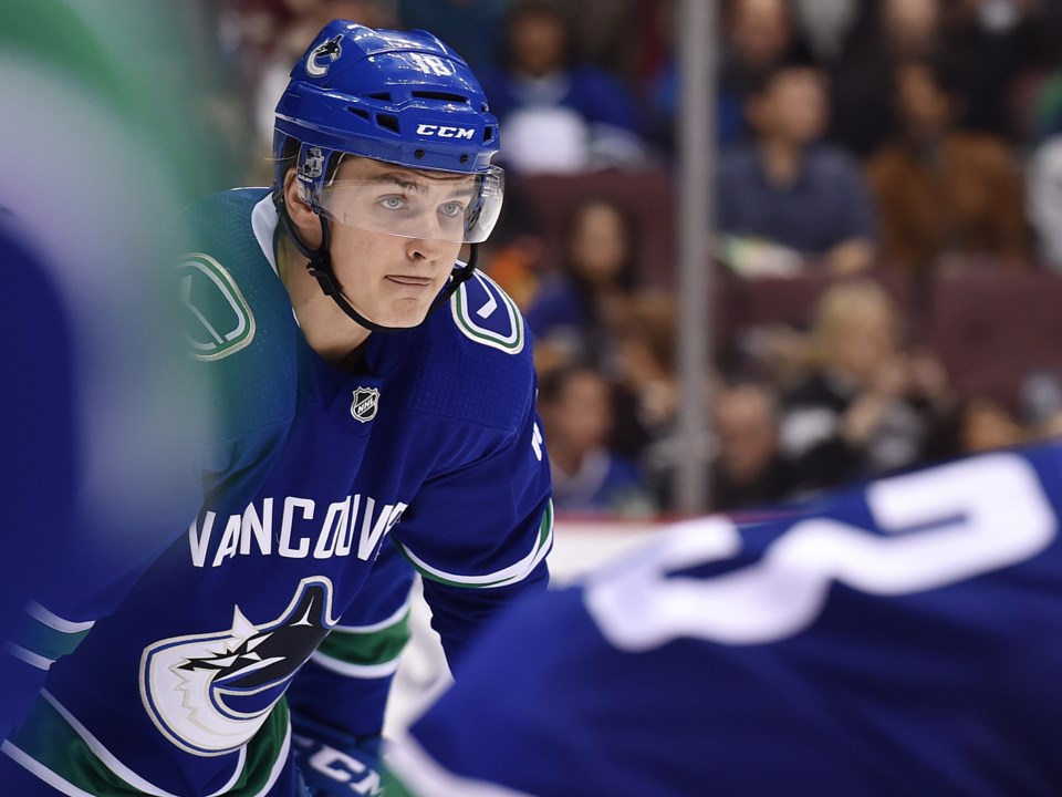 Jake Virtanen waits for the puck to drop on a faceoff.