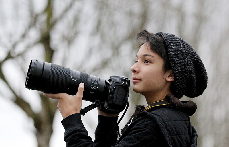 MARIO BARTEL/THE TRI-CITY NEWS Adam Dhalla, 13, now wields a 200-500mm telephoto zoom lens attached to his Nikon digital camera that he uses to capture images of birds he sees during spotting expeditions. That's an upgrade from the little point-and-shoot camera he used when he first started the hobby five years ago. The Coquitlam teen has been honoured by the American Birding Association as its 2018 young birder of the year for his photography and advocacy for bird conservation.