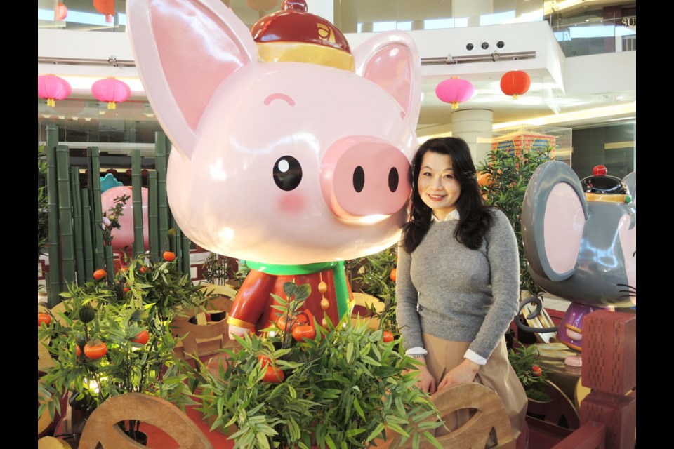 Aberdeen Centre's director of public relations, Joey Kwan, with her latest creation for the Year of the Pig. During her 12 years working at the centre, Kwan has helped design each of the 12 animals of the Chinese zodiac, which are being displayed together for the first time. Alan Campbell photos