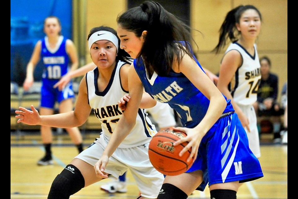 McMath Wildcats' Grade 8 standout Marina Radocaj is guarded by Steveston-London's Sharlene Siy during Saturday's championship game at the Bob Carkner Memorial Classic. McMath defeated the host Sharks 92-69 with Radocaj scoring a game-high 26 points. She was joined by Siy on the tournament all-star team.