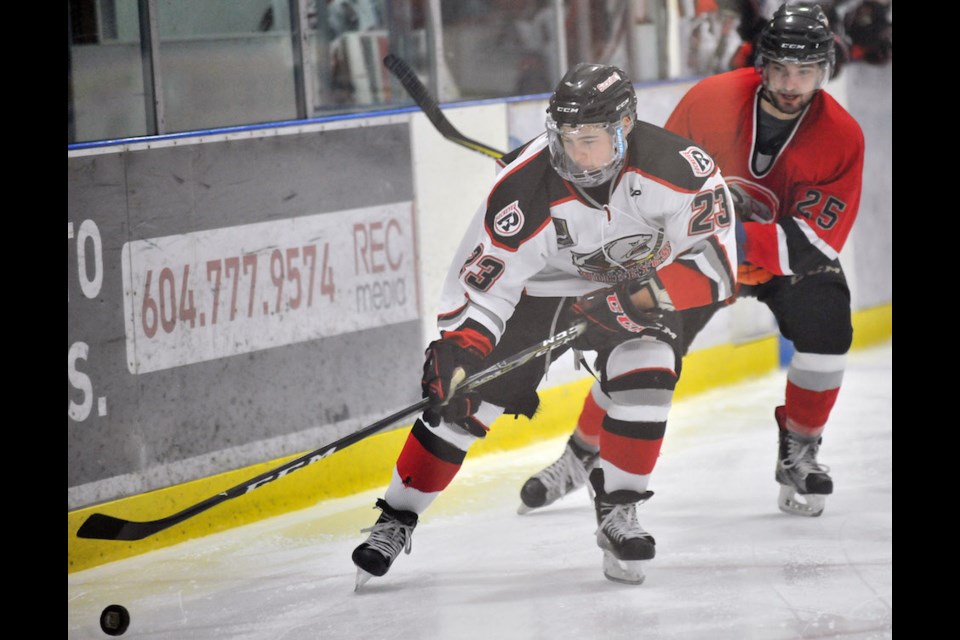 Brett Geltz closes in on Noah Kelly during the Richmond Sockeyes' 17th annual Alumni Game on Saturday at Minoru Arenas. The grads skated to a 5-3 victory over the current team.