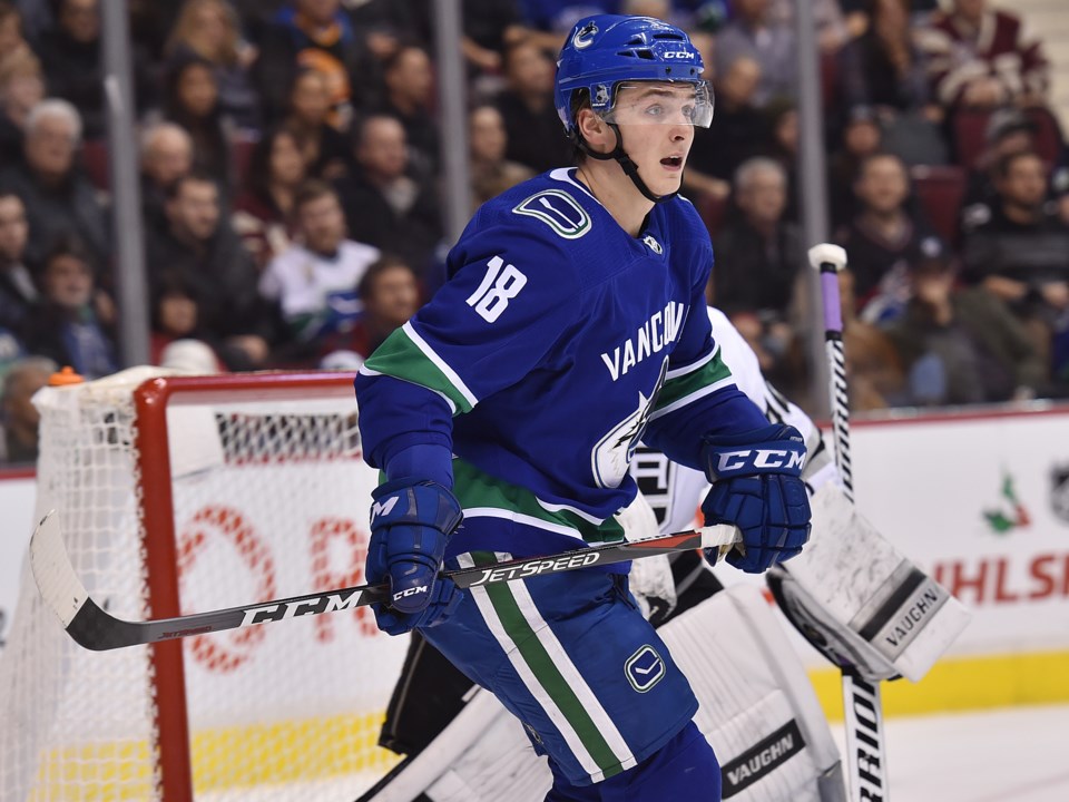Jake Virtanen defends in his own zone for the Vancouver Canucks.