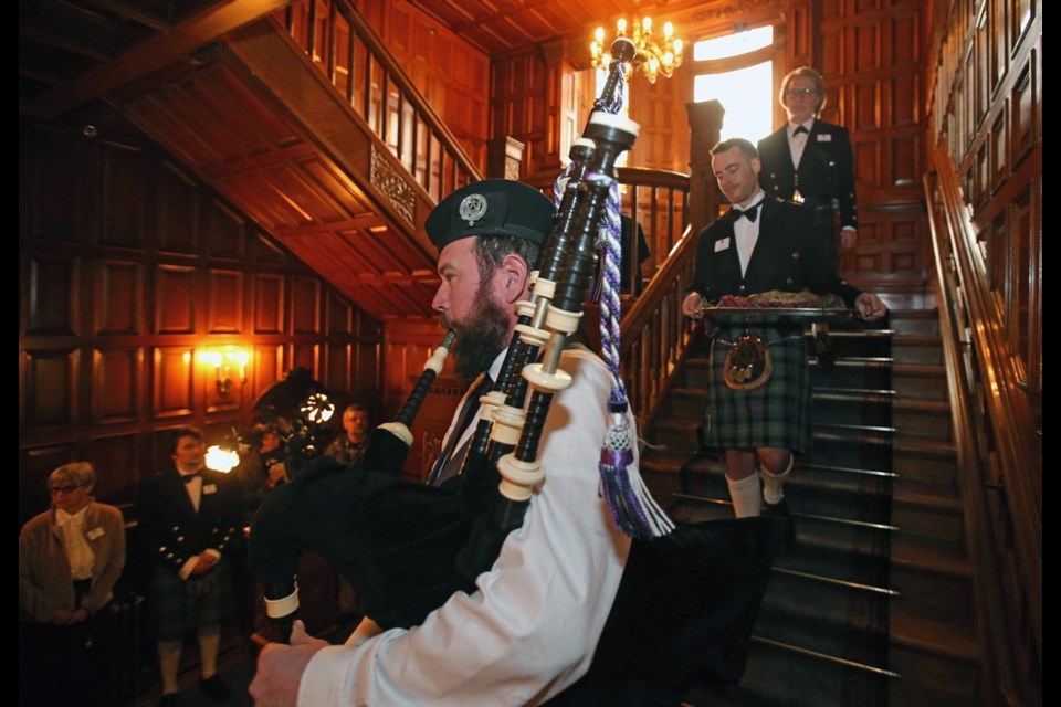 Piper Cole Griffith, left, leads the haggis carried by Darren Findlay, with Bruce Davies behind, during the Robbie Burns Day celebrations at Craigdarroch Castle on Friday, Jan. 25, 2019. The Celtic band Cookeilidh added to the fun.