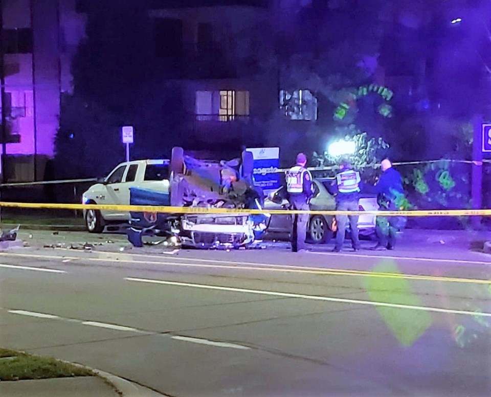 A taxi flipped on its roof after hitting a median