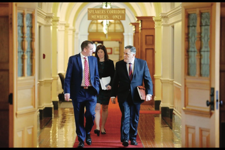 Speaker Darryl Plecas, right, his special adviser Alan Mullen and deputy legislative clerk Kate Ryan-Lloyd leave Plecas's office to deliver his report on the legislature scandal on Jan. 21.