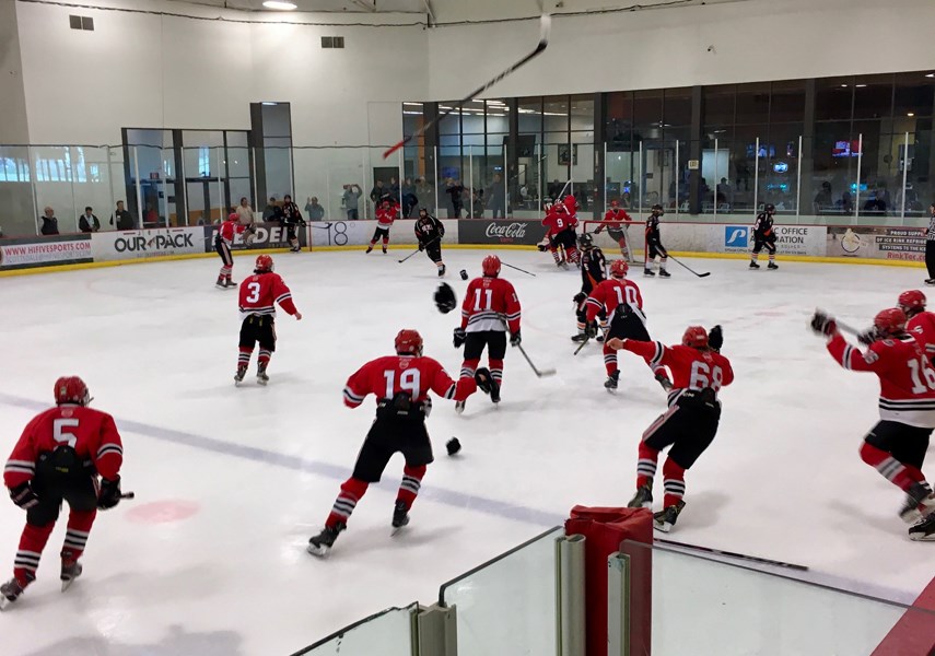 Members of the North Shore Winter Club midget A1 team celebrate their championship win at the Cactus Cup International Tournament in Phoenix, Ariz. photo supplied