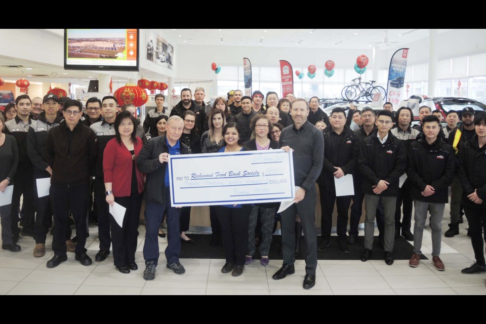 The social committee at Richmond Honda, called the “The Winning Team,” organize company fundraising events, such as bake sales and 50/50 draws. The staff are pictured presenting $3,800 to the Richmond Food Bank.