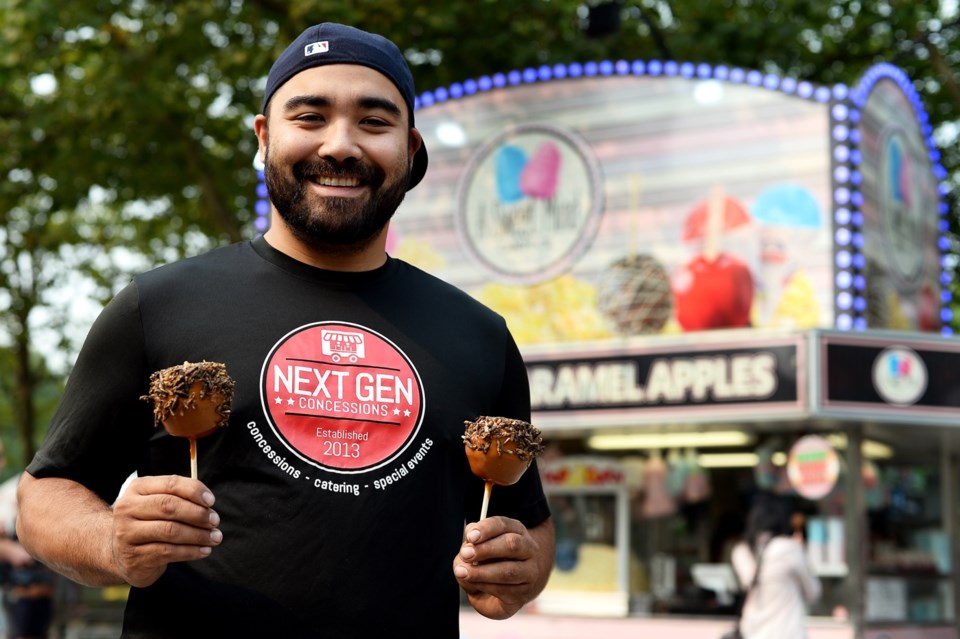 Jason Faria of Next Gen Concession with his creation, the cricket caramel apple at the Fair at the P