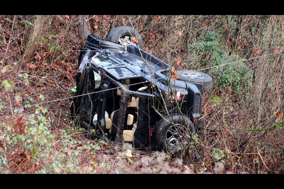 A driver lost control of this Jeep, hit a guardrail and then ended upside down early this morning along Columbia Street. SHANE MACKICHAN PHOTO