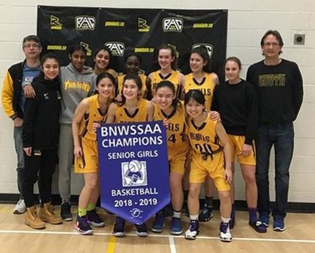 The Burnaby South Rebels celebrate their league playoff victory Tuesday, edging Burnaby Central 58-57 on a last-second shot.